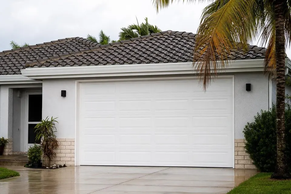 Impact-rated sectional garage door on a South Florida stucco home
