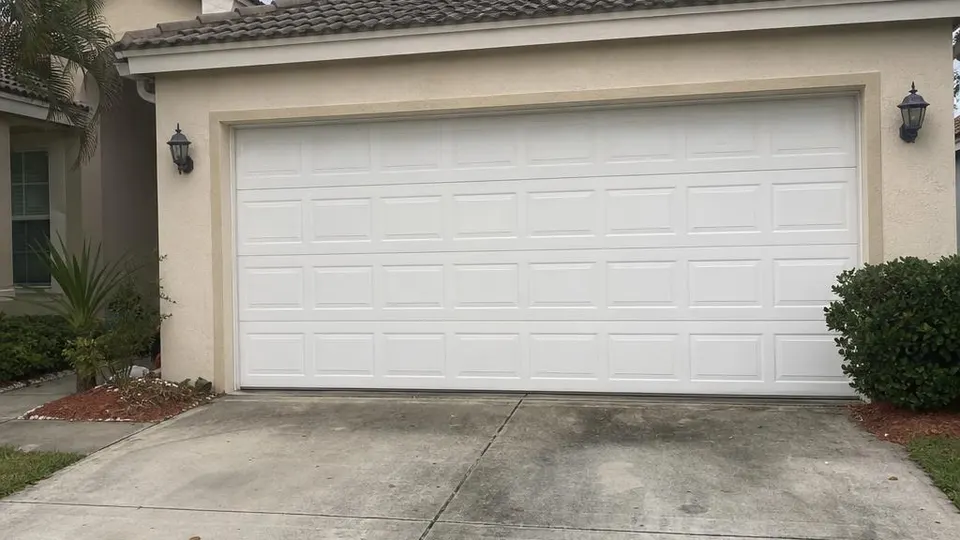 Standard white garage door on a suburban Florida house